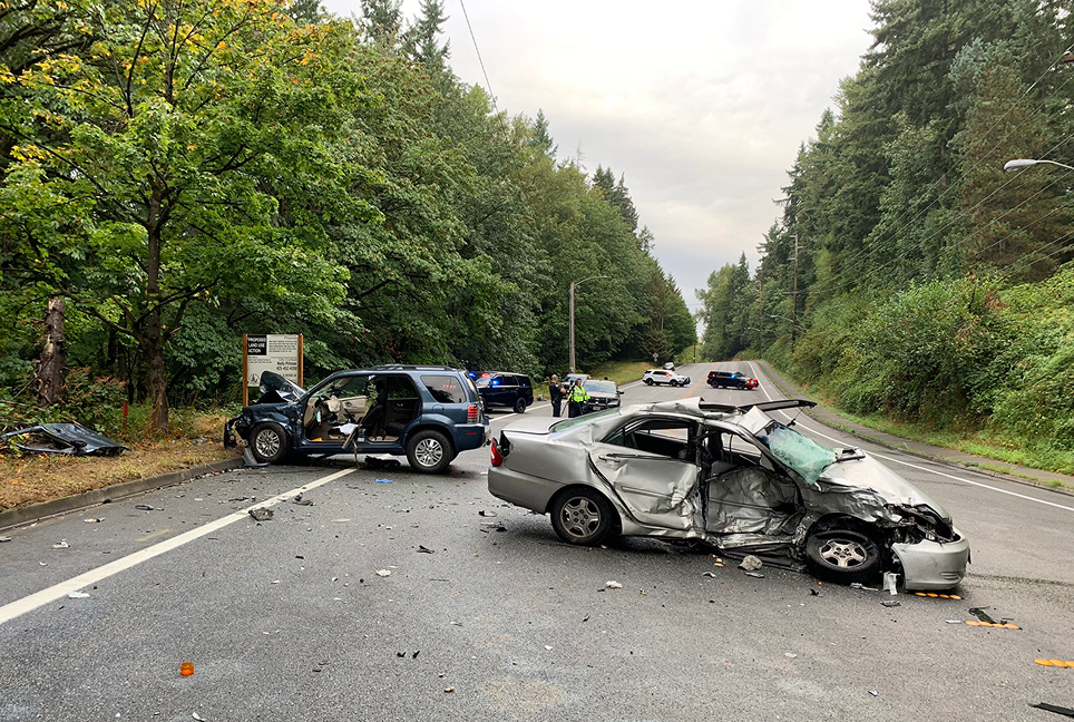 Two cars, destroyed, on a road in Bellevue