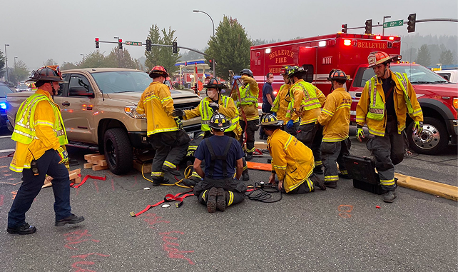 Firefighter crew in a road, next to an ambulance